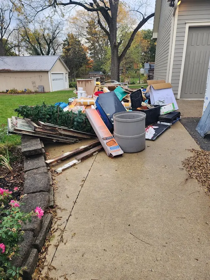 Dumpster being loaded with debris for Estate Cleanout Dumpster Rental in Meadowbrook
